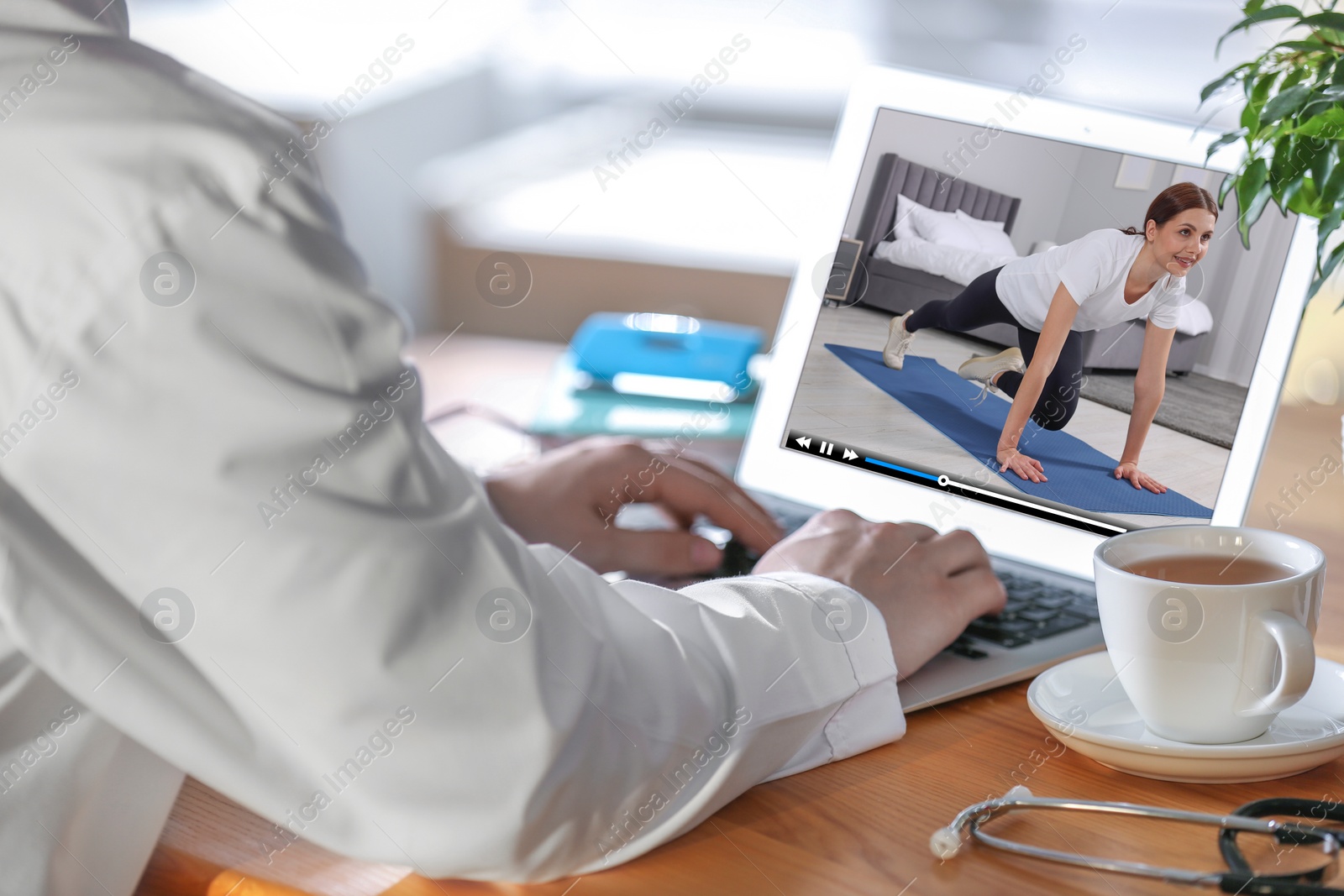 Image of Man watching morning exercise video on laptop at home, closeup