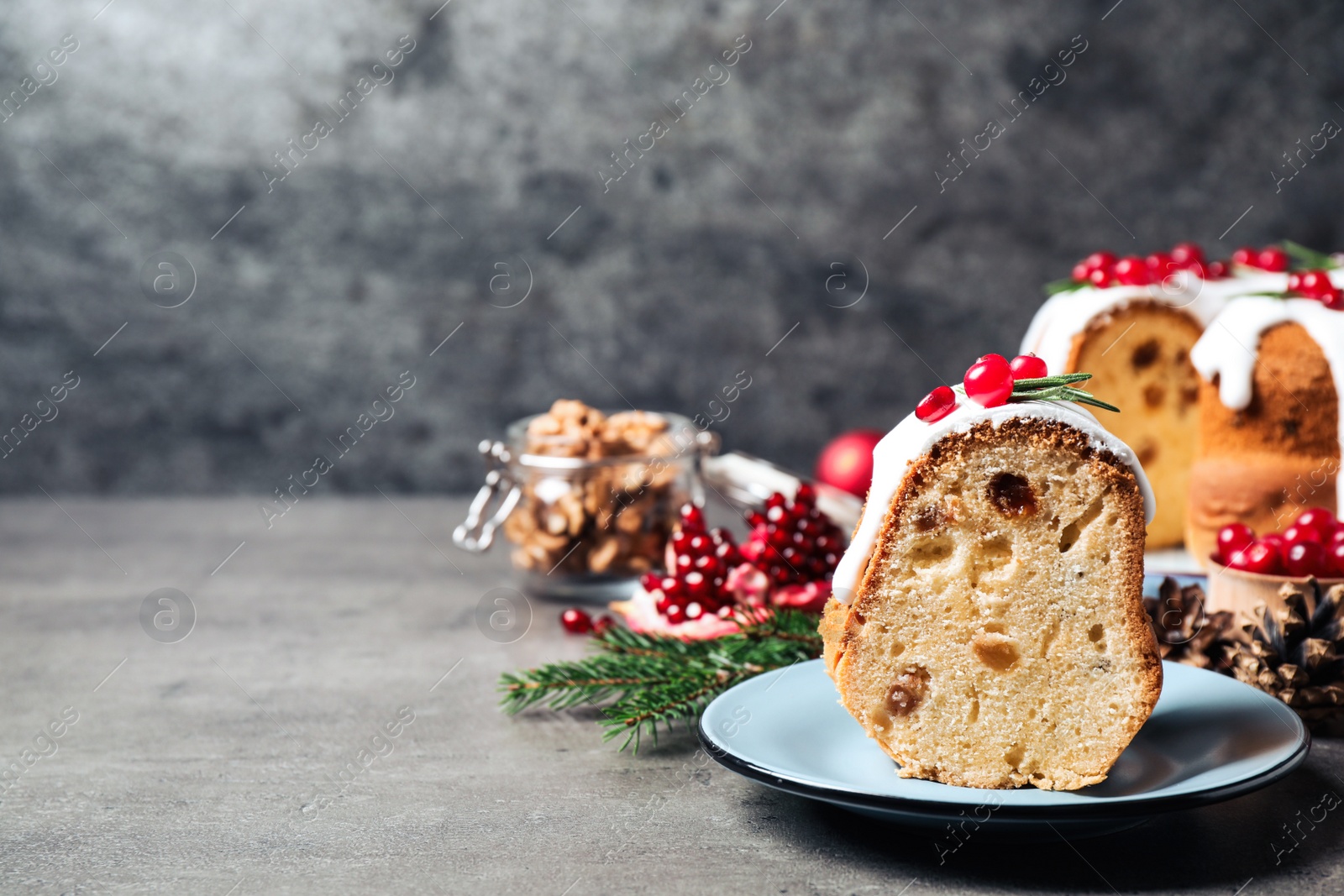 Photo of Composition with piece of traditional homemade Christmas cake on grey table, closeup. Space for text