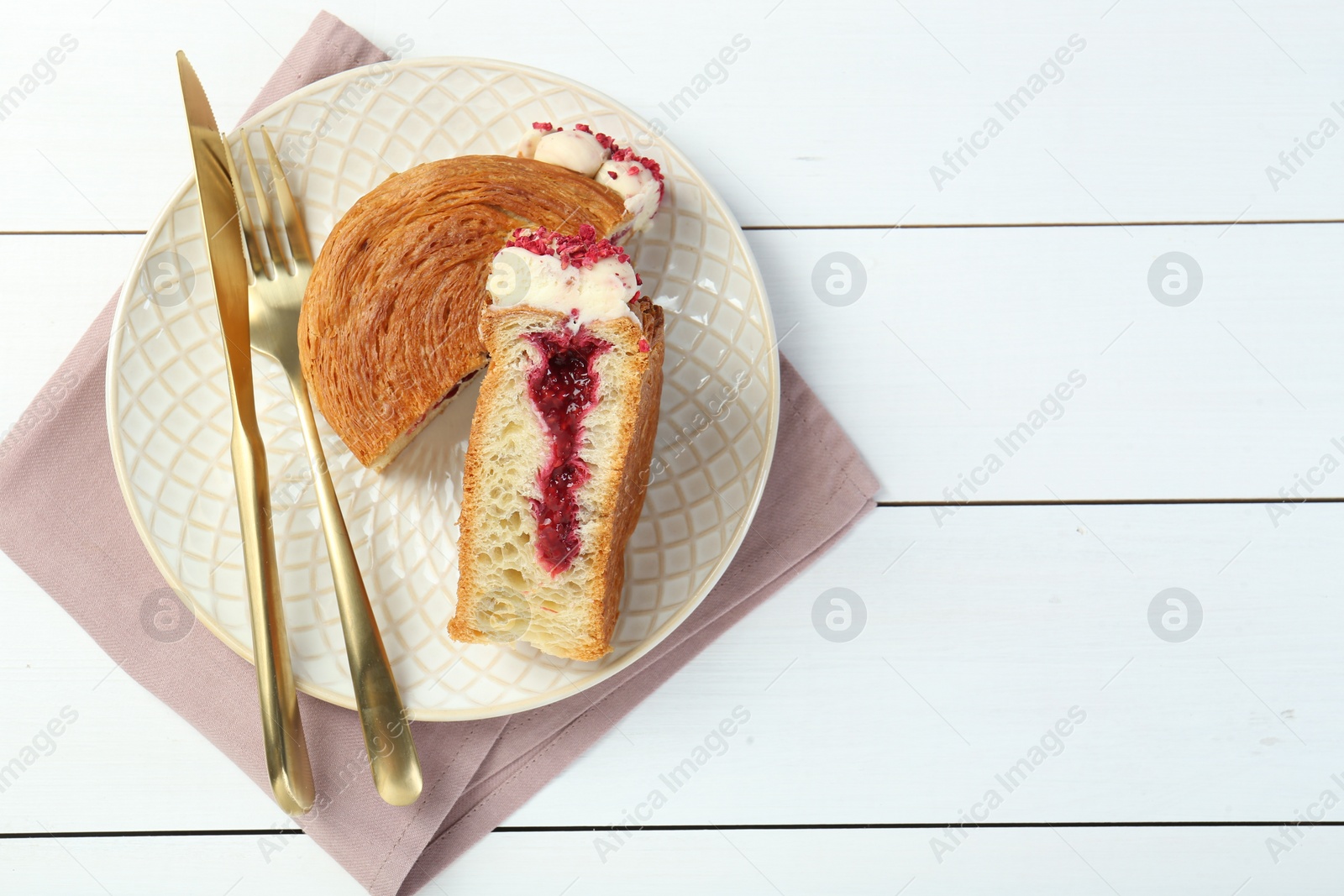 Photo of Tasty puff pastry. Round croissant with jam on white wooden table, top view. Space for text