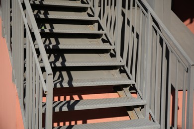 Photo of View of beautiful metal stairs with railings outdoors, closeup