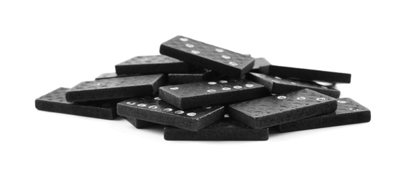 Pile of black domino tiles on white background