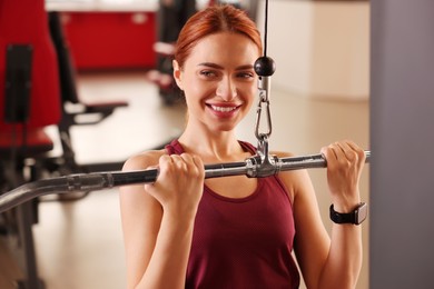 Photo of Athletic young woman training in modern gym