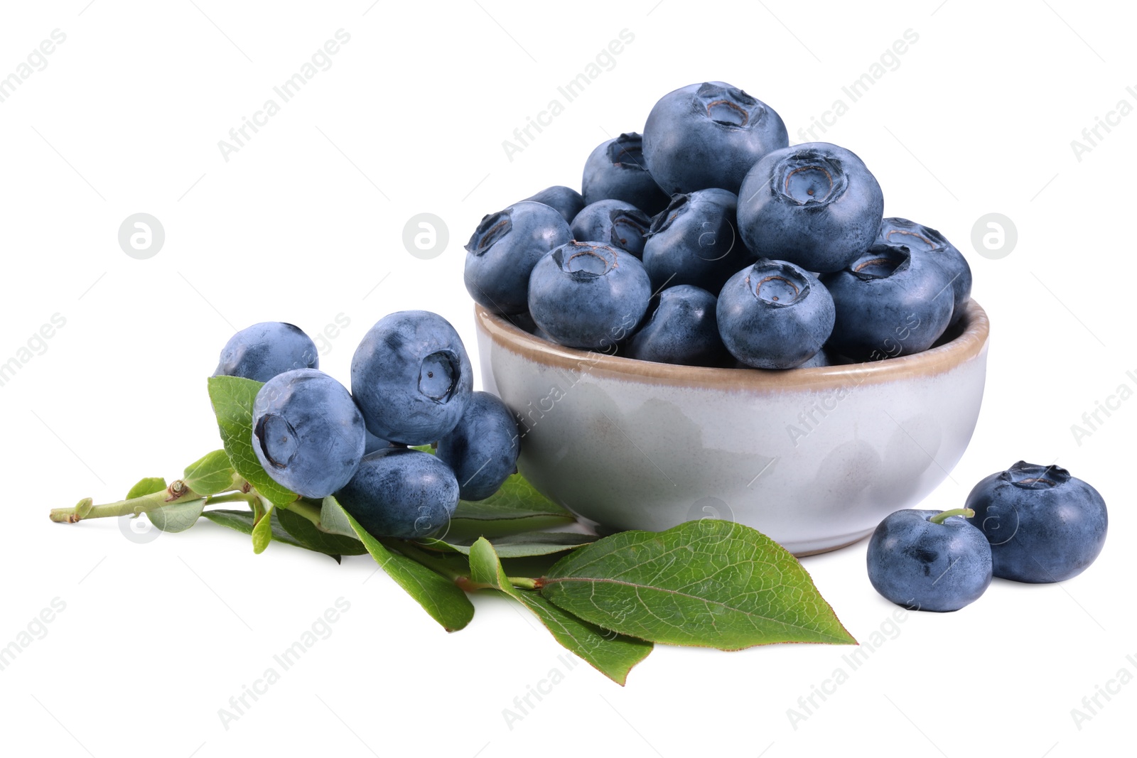 Photo of Fresh ripe blueberries and leaves isolated on white