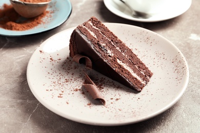 Plate with slice of tasty homemade chocolate cake on table