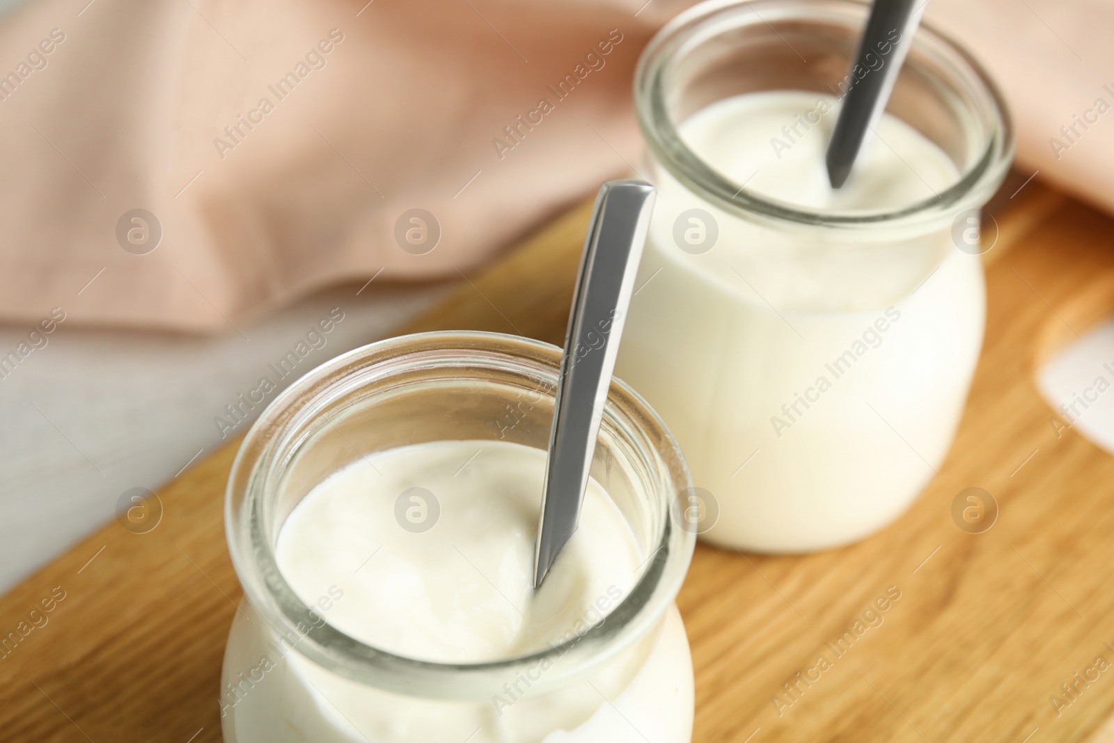 Photo of Tasty organic yogurt in glass jar, closeup