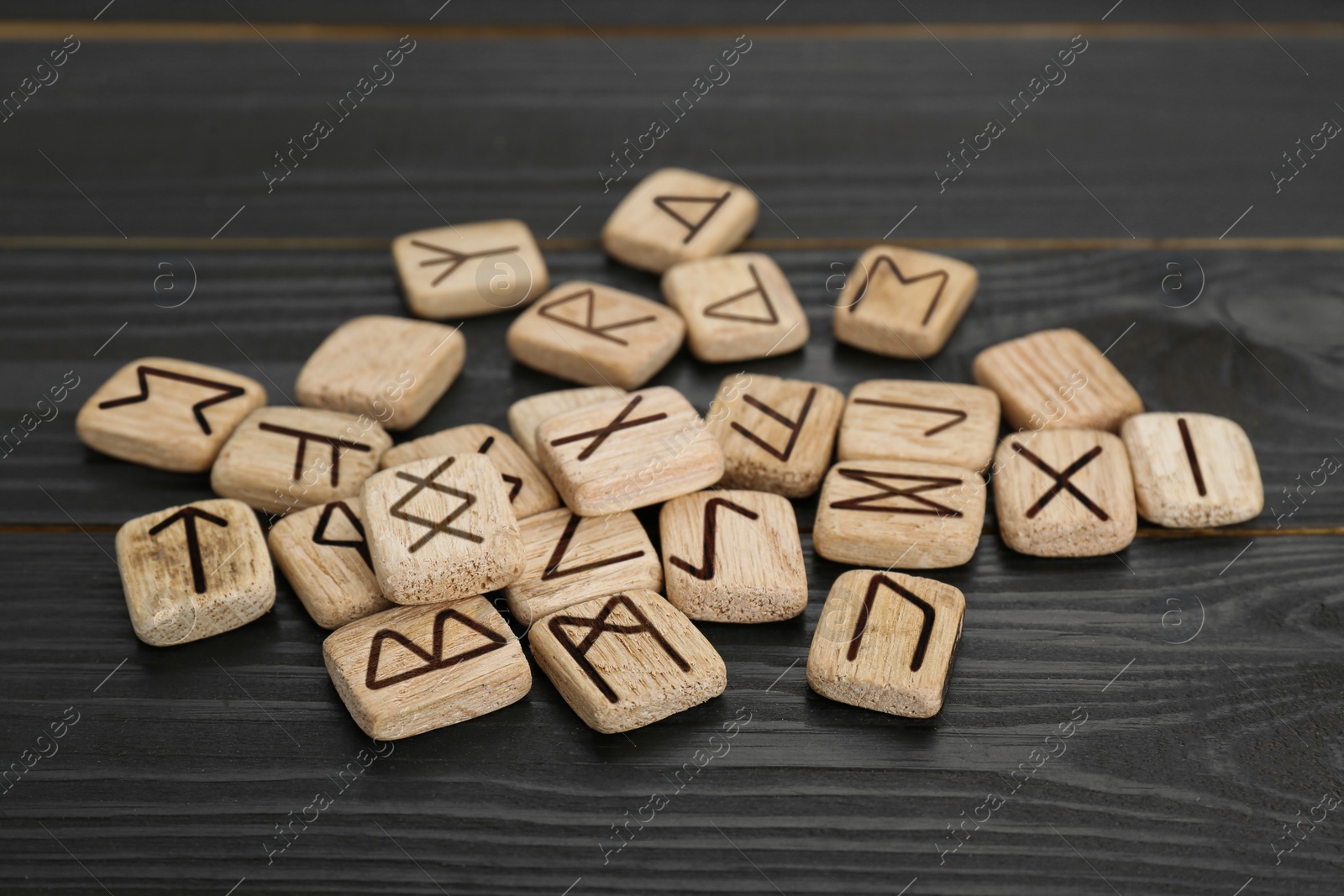 Photo of Pile of runes on black wooden table