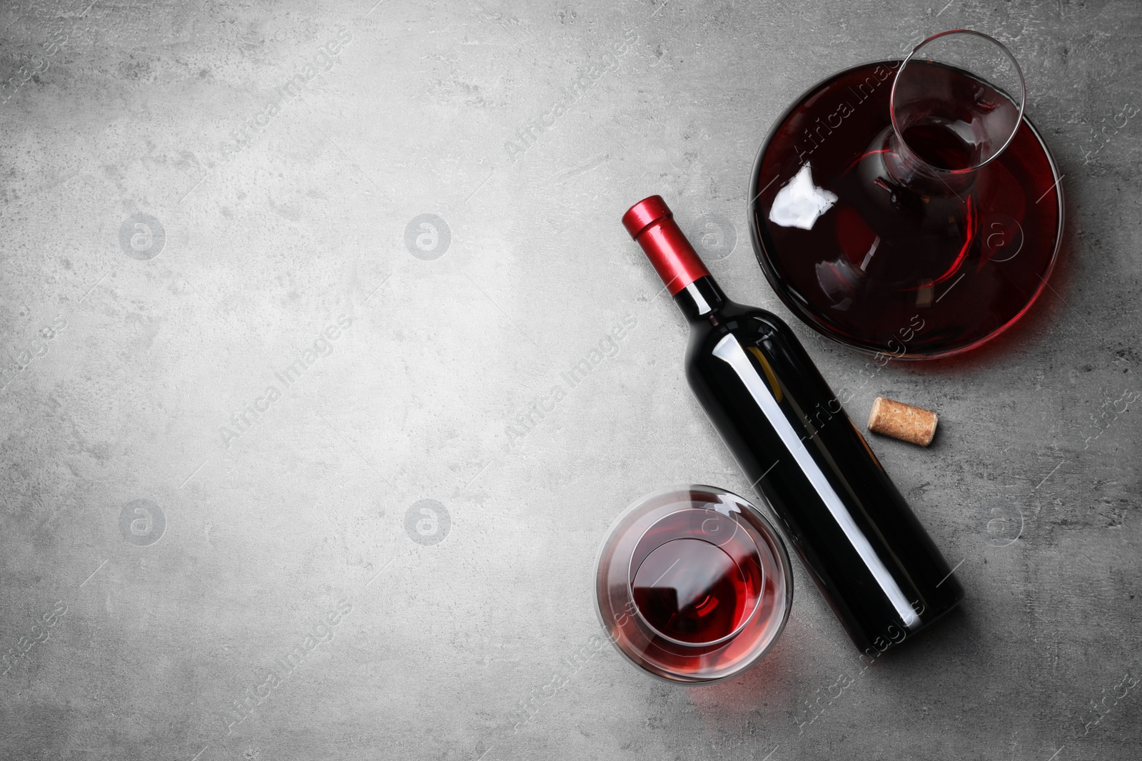 Photo of Decanter, glass and bottle with red wine on color background, flat lay. Space for text