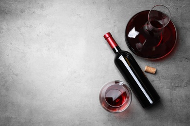 Photo of Decanter, glass and bottle with red wine on color background, flat lay. Space for text