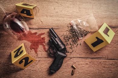 Flat lay composition with evidences and crime scene markers on wooden background