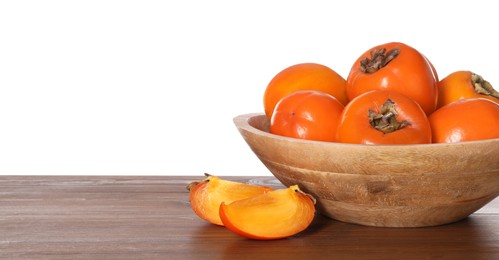 Photo of Delicious ripe juicy persimmons with bowl on wooden table against white background