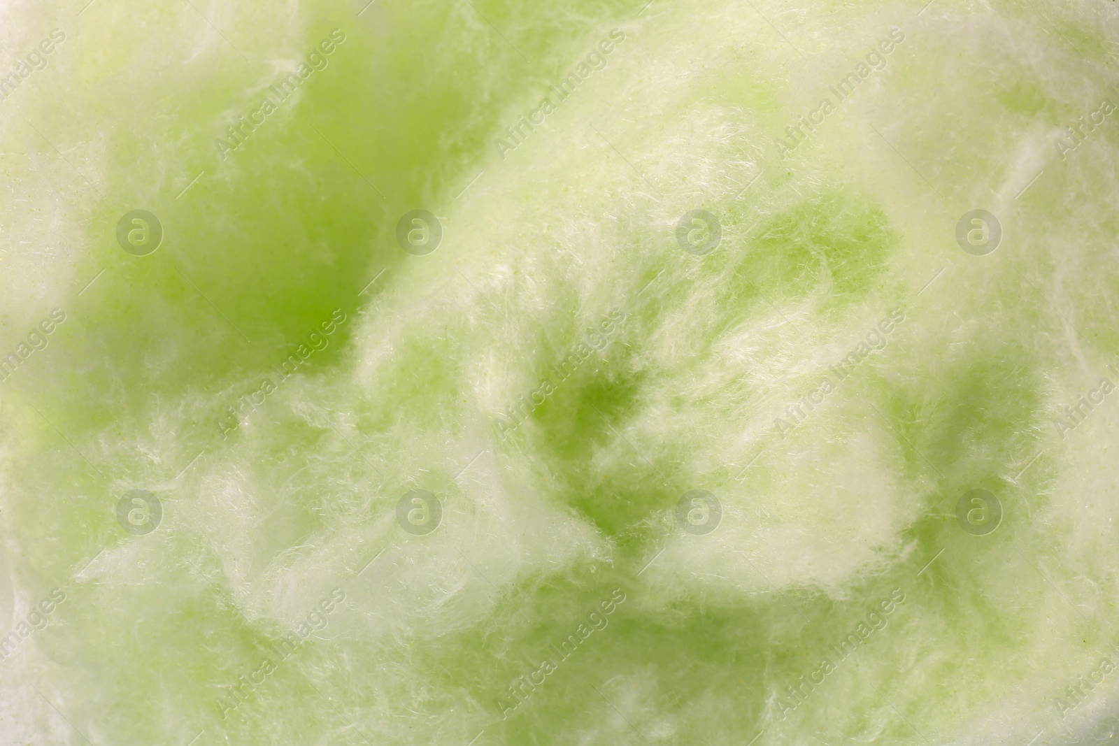 Photo of Green cotton candy as background, closeup view