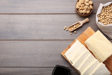 Photo of Different natural soy products on wooden table, flat lay. Space for text
