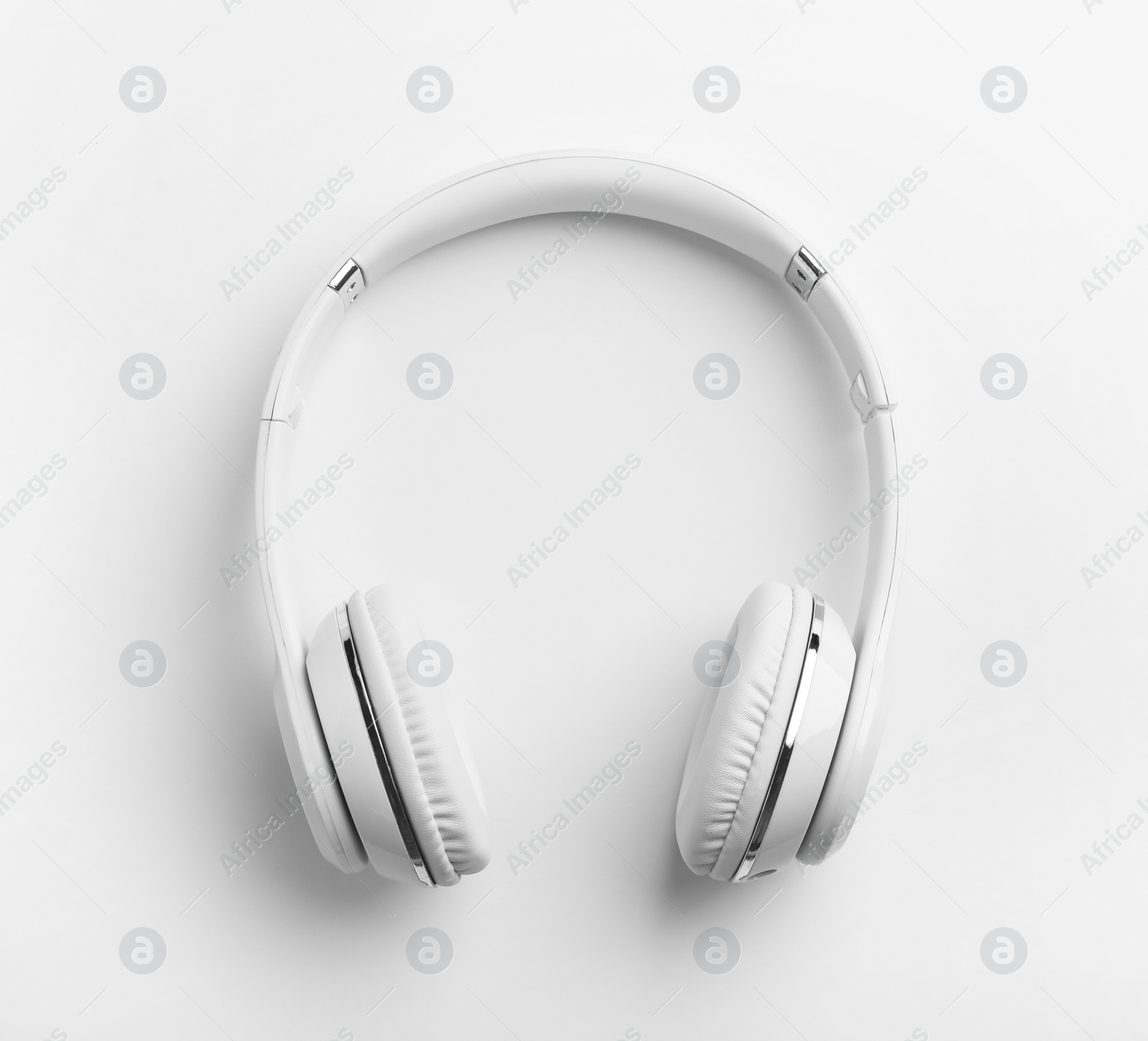 Photo of Stylish modern headphones with earmuffs on white background