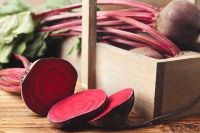 Cut raw ripe beet on wooden table