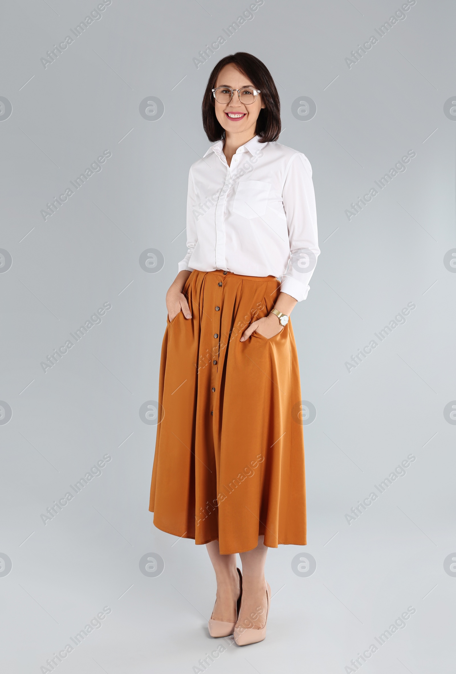 Photo of Full length portrait of mature businesswoman on light grey background