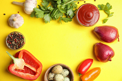 Photo of Frame of ingredients for cooking on yellow background, flat lay. Space for text