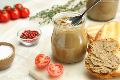 Photo of Tasty liver pate, bread and tomato on white board