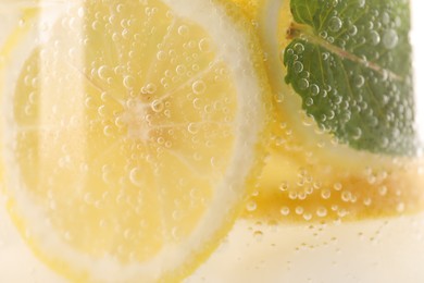 Photo of Freshly made lemonade with mint in jug as background, closeup