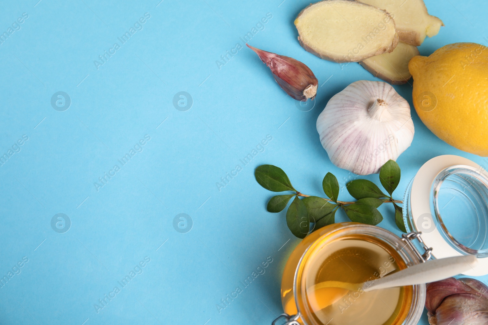 Photo of Flat lay composition with garlic and other cold remedies on blue background. Space for text