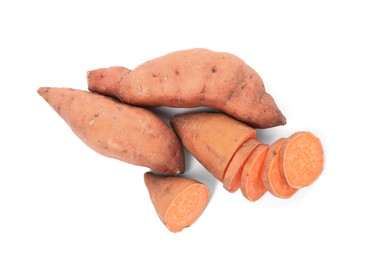 Whole and cut ripe sweet potatoes on white background, top view