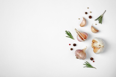 Photo of Composition with garlic, pepper and rosemary on white background, top view. Space for text