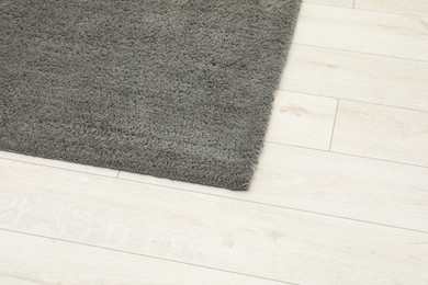 Soft grey carpet on white laminated floor indoors, top view. Space for text