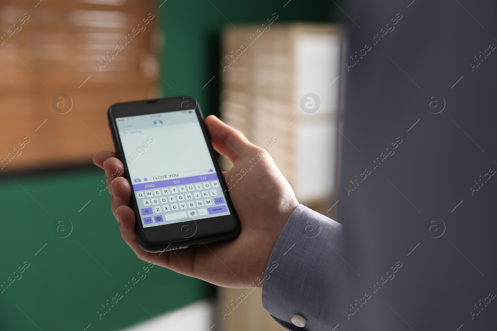 Photo of Man sending message with text I Love You indoors, closeup