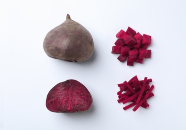 Photo of Composition with whole and cut beets on white background, top view