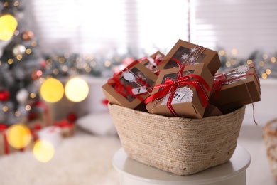 Photo of Basket full of gift boxes for Christmas advent calendar in room, space for text
