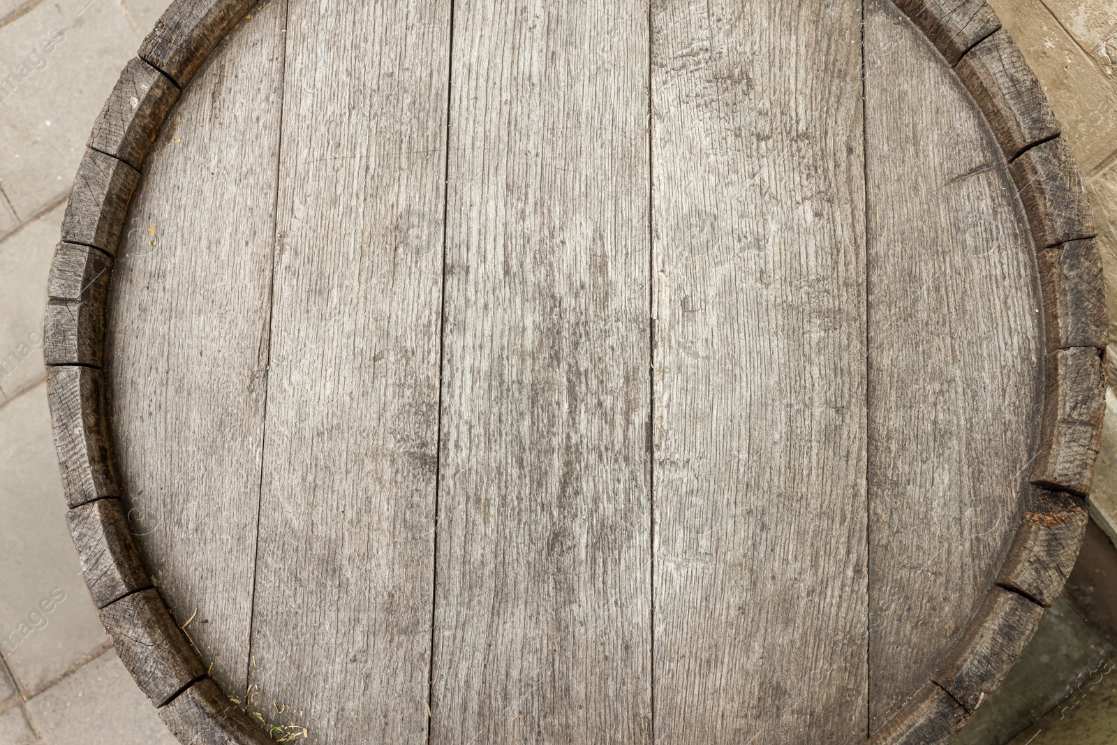 Photo of Traditional wooden barrel outdoors, top view. Wine making