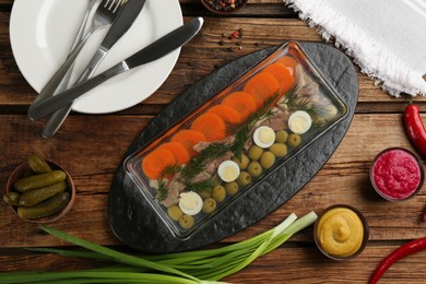 Photo of Delicious aspic with meat served on wooden table, flat lay