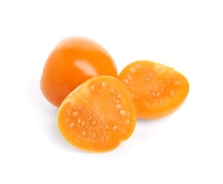 Cut and whole ripe physalis fruits on white background