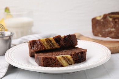 Photo of Slices of delicious banana bread served on table, closeup
