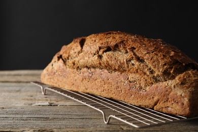 Photo of Freshly baked sourdough bread on wooden table, closeup