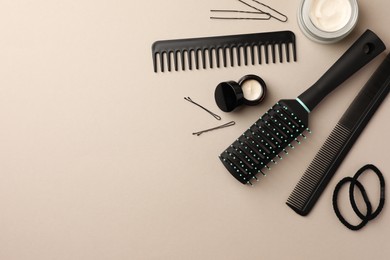 Brush, combs and different hair products on light grey background, flat lay. Space for text