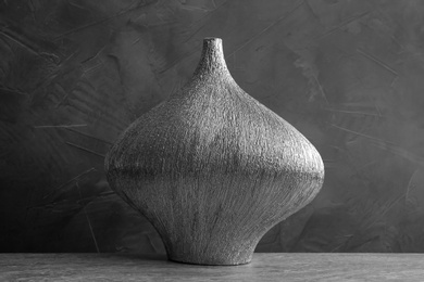 Photo of Stylish silver ceramic vase on grey table