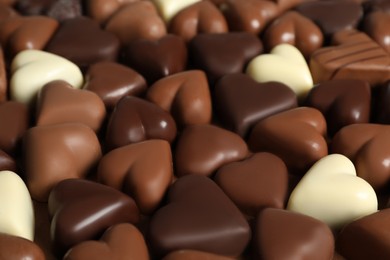 Beautiful heart shaped chocolate candies as background, closeup