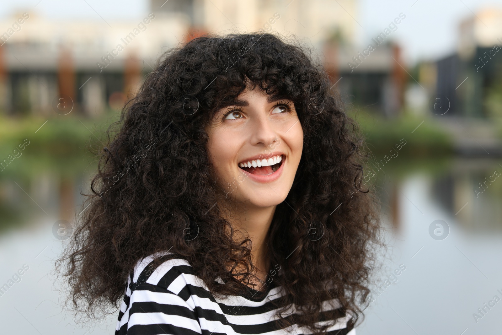 Photo of Portrait of beautiful woman outdoors. Attractive lady smiling and posing for camera