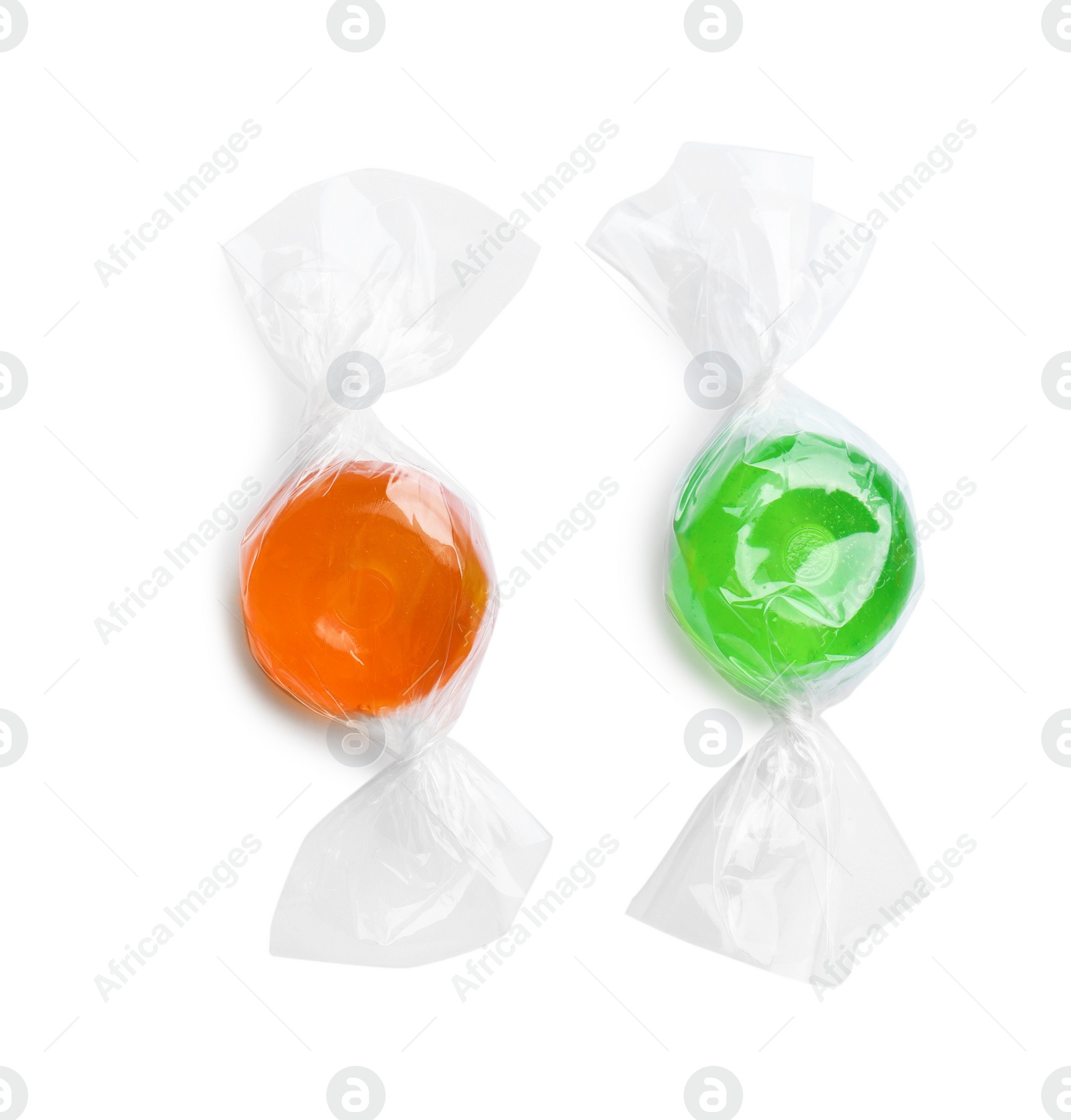 Photo of Different delicious colorful candies on white background, top view