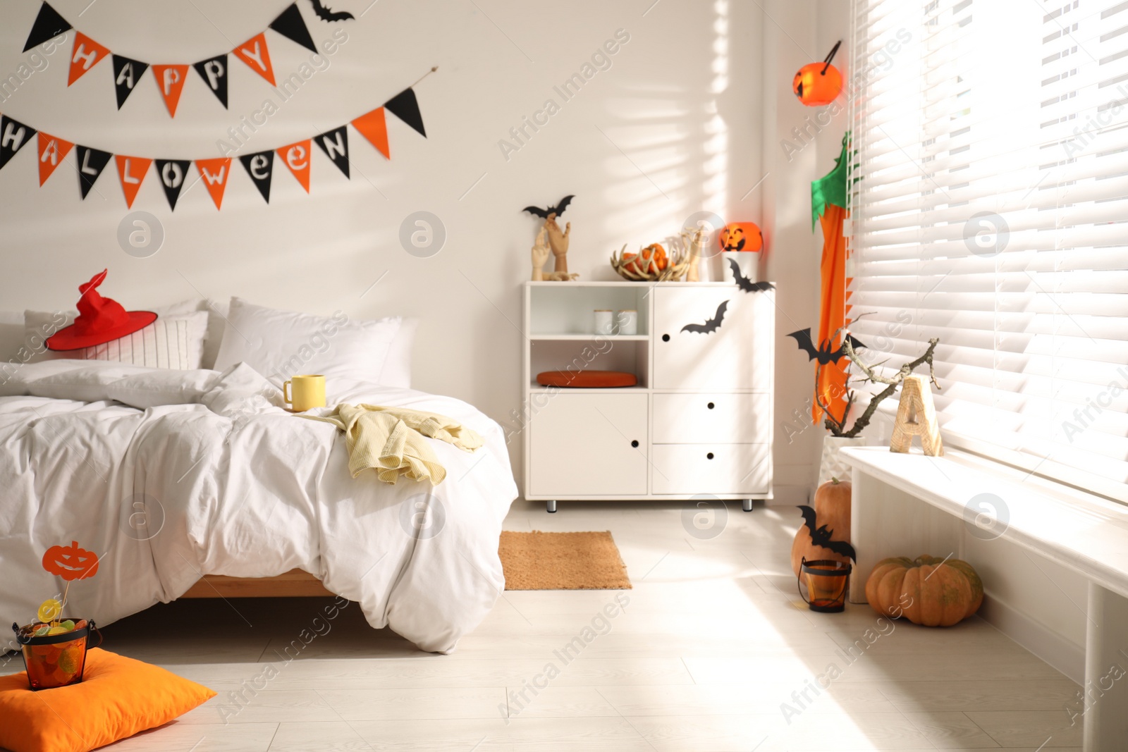 Photo of Stylish bedroom interior with festive Halloween decor