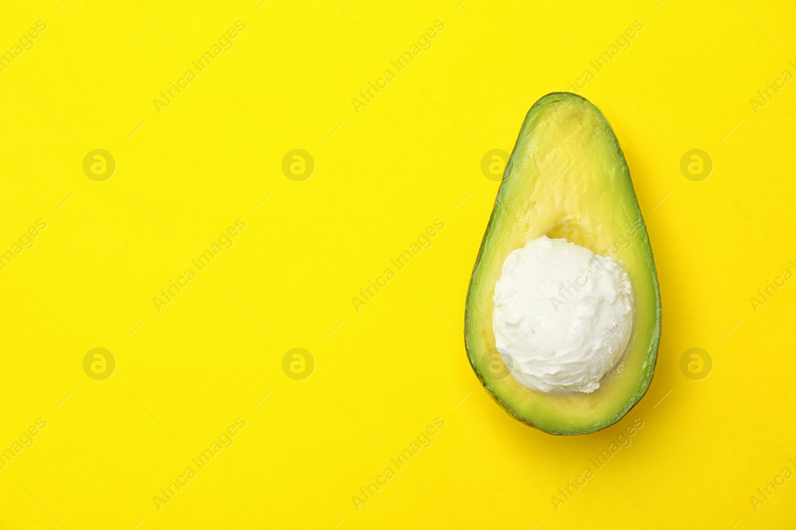 Photo of Composition with ripe avocado and ice cream on color background, top view