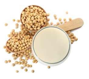 Glass of fresh soy milk and beans on white background, top view