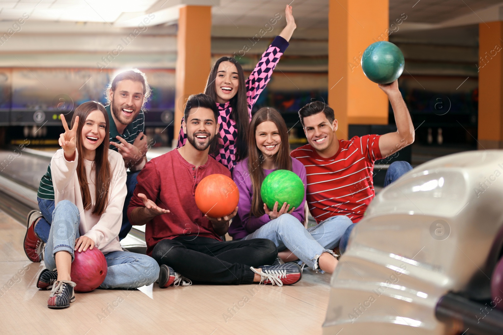 Photo of Group of friends with balls in bowling club