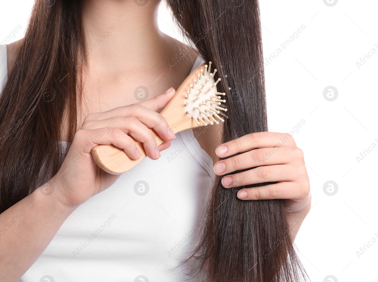 Photo of Woman with hair brush on white background, closeup