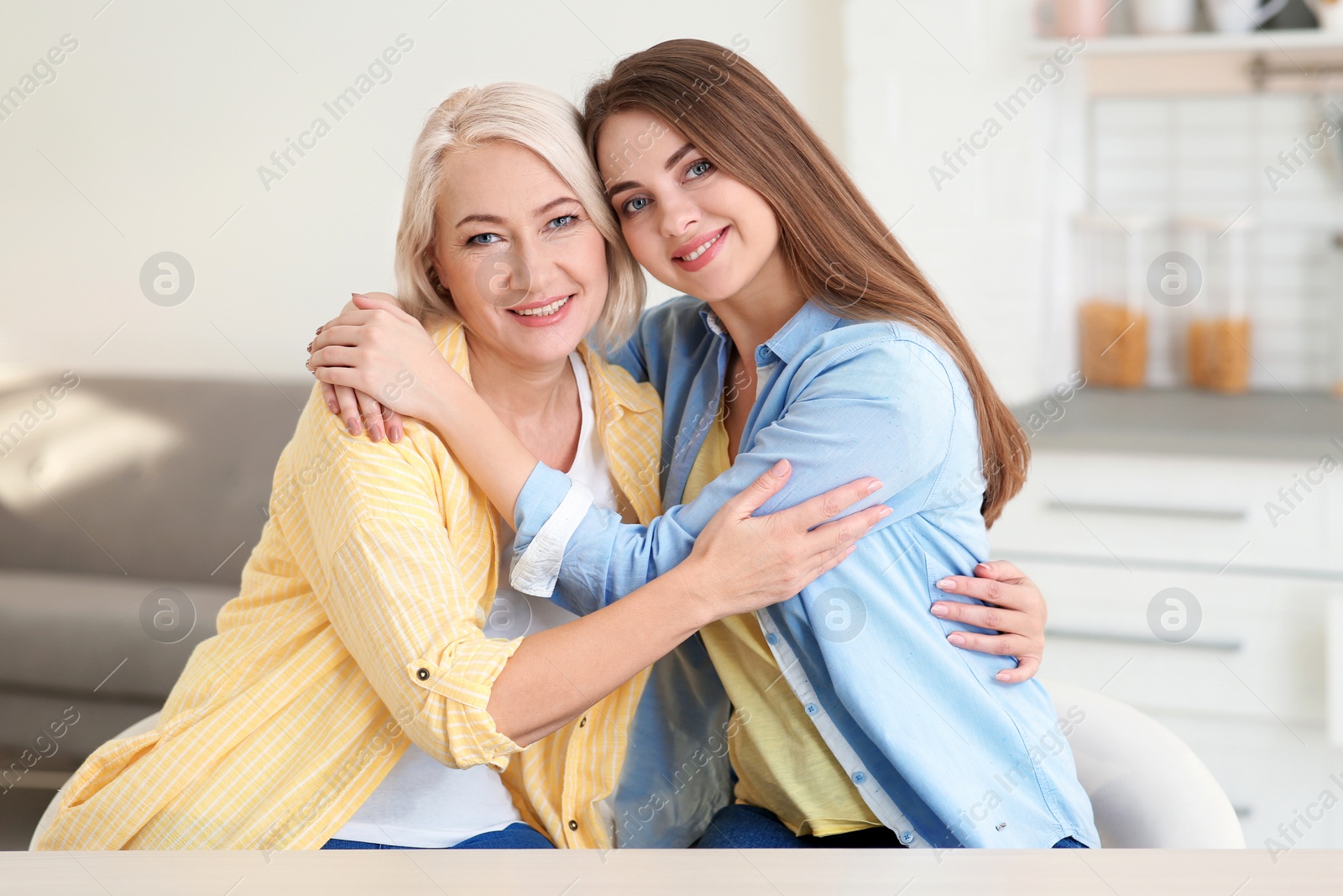 Photo of Portrait of young woman with her mature mother at home