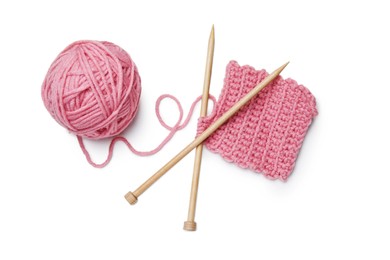 Photo of Soft pink woolen yarn, knitting and wooden needles on white background, top view