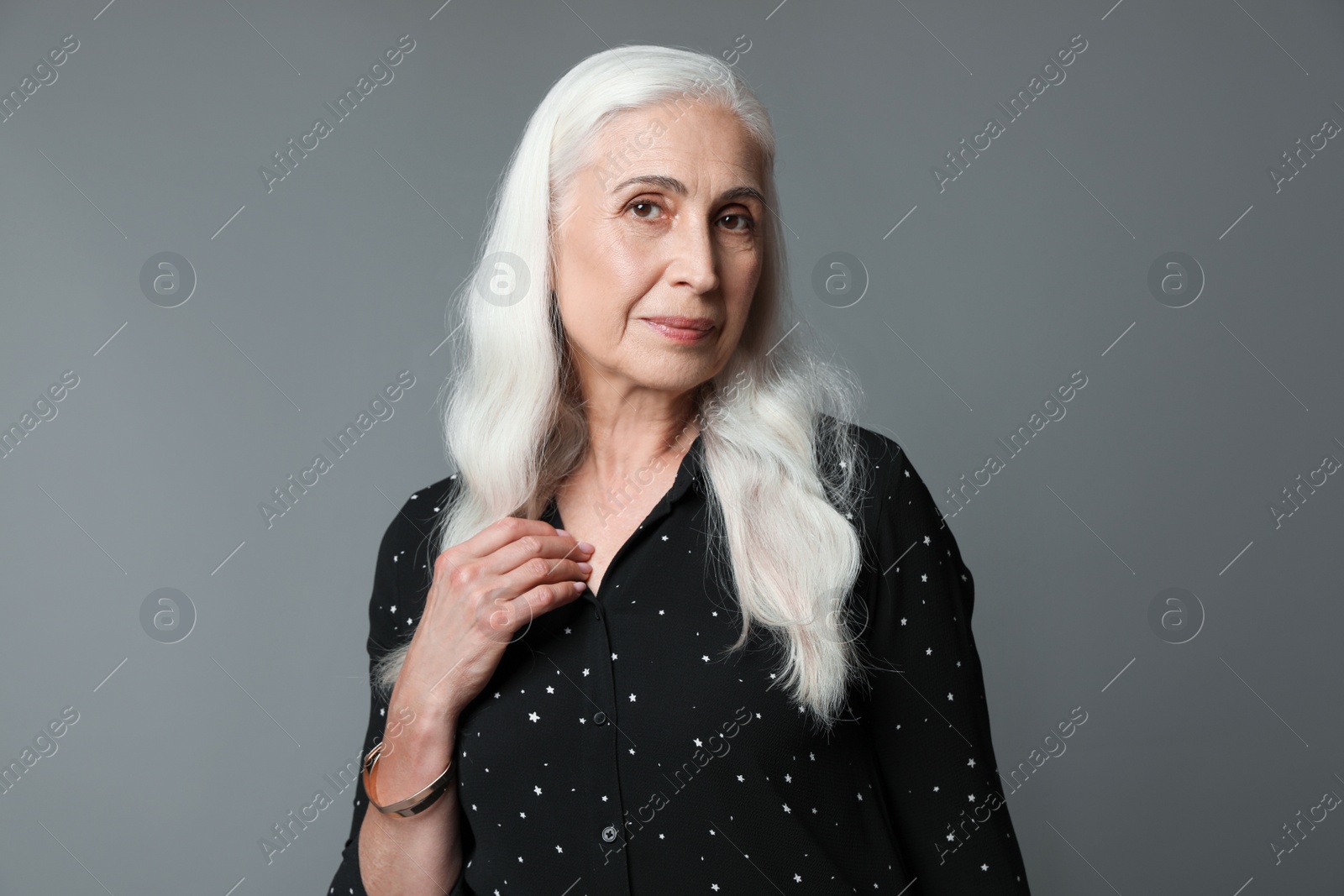 Photo of Portrait of beautiful mature woman on grey background