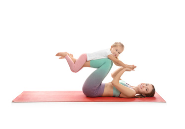 Young woman and her daughter doing exercise isolated on white. Home fitness