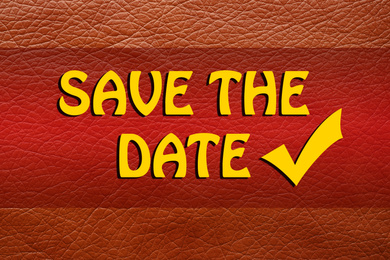 Phrase SAVE THE DATE on orange leather, top view  