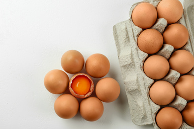Photo of Raw chicken eggs on white table, flat lay